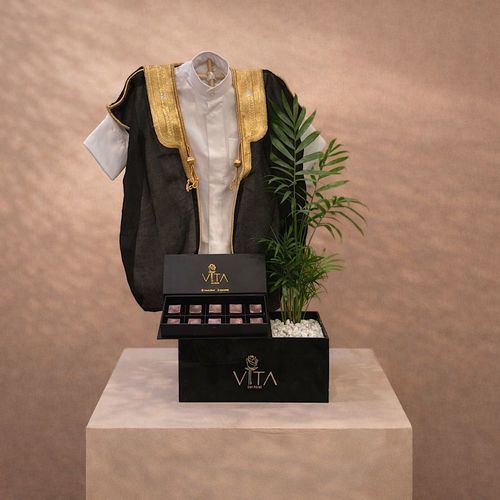 Leafora - Black box contains Parlor palm with baby deshdasha, baby bisht and a box of chocolates. Height: 50 Width: 20
