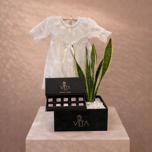 Botanica - Black box contains Snake plant with Comes with a white dress for a newborn baby. and a box of chocolates. 
 ارتفاع : ٥٠&nbsp; عرض : ٢٠