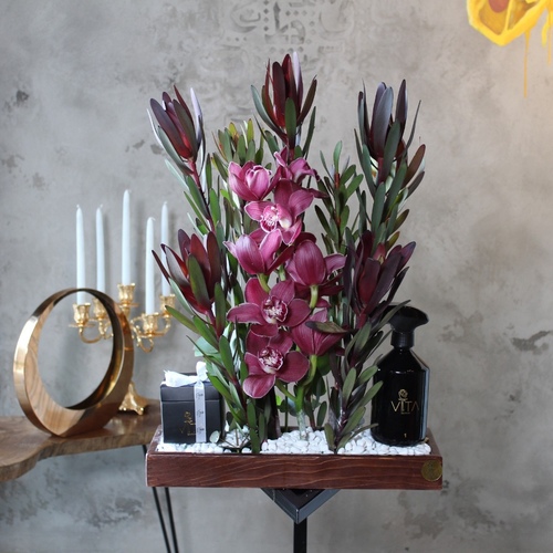 Yuppie - A wooden tray contains purple cymbidium and safari sunset with home fragrance and a box of chocolates. 
 H: 60  W: 40