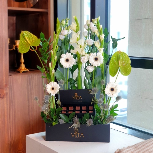 lama - black box contains green antuiom , white grabera , green leaves and baby roses white with box of chocolate 
 H 60 w 30