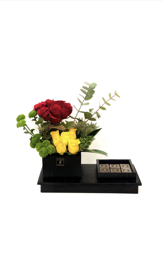 A 13 - Wooden base contains natural flowers and chocolate.