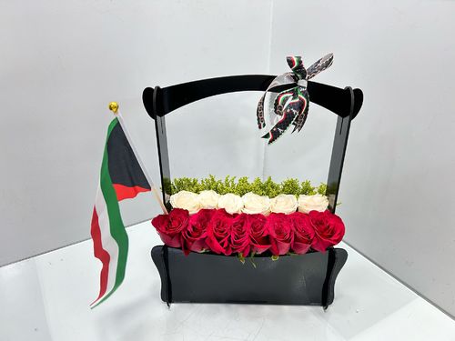 design 1 - wooden box with a luxurious flower
  arrangement decorated with the Kuwaiti flag