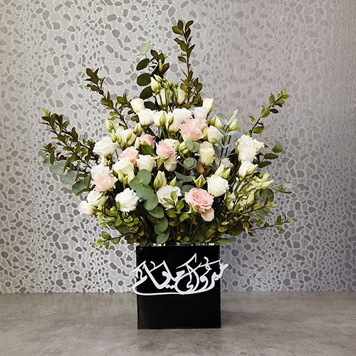 Eirlys 2 - Height: 55 cm
Width: 40 cm

A box that contains baby rose and lisianthus flowers.