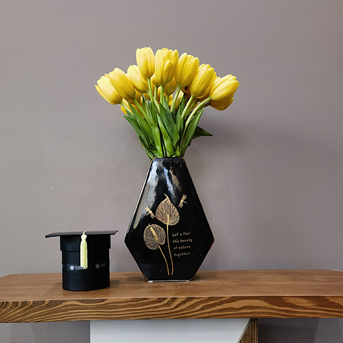 Graduation Tulips - Height: 40 cm
Width: 30 cm

This vase is filled with tulip flowers with a box of chocolates.