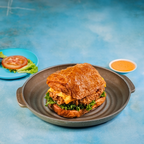 Croissant Chicken Burger - Lollo rosso lettuce, pickles, american cheese and miami sauce.