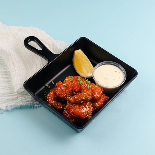 Buffalo Shrimp - Buffalo shrimp, lemon wedges, spring onions and ranch sauce.