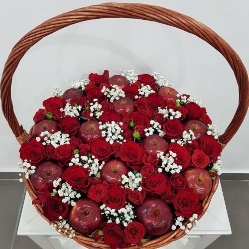 Fruits Basket 705 - A fruit and flowers basket that contains 23 Red roses, 4 stems Red baby roses 2 stems white gypsophilia . Fruits : 13 red apples. diameter 50cm