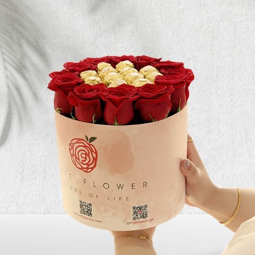 Sun 304 - an amazing circular bow of 12 red roses filled with golden Ferrero chocolates height 23 cm width 20 cm