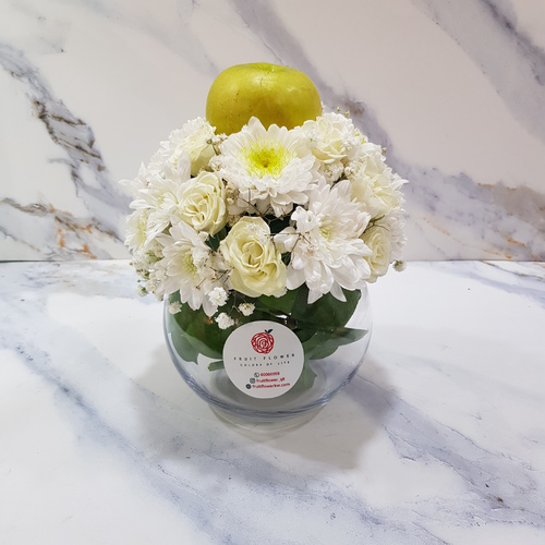 The White - White Craze And White Baby Rose With Green Apple In Medium  Round Glass Vase 523 - Baby Rose White, White Craze, Gypsophilia And Green Ruscus With Green Apple In Round Glass Vase.  Height- 24 cm Width- 20 cm