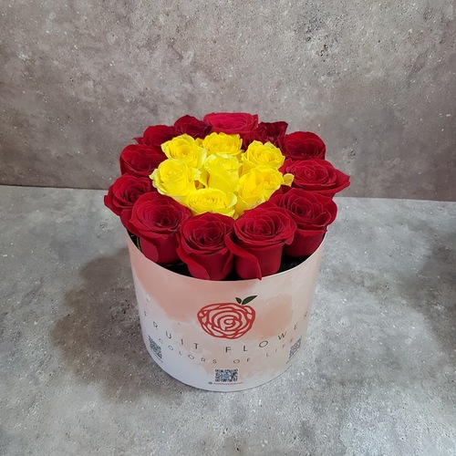 yellow and red roses in a round box 1129 - This stunning arrangement features a combination of vibrant red and yellow roses beautifully arranged in a round box. The roses are carefully selected for their vibrant colors and fresh fragrance, creating a visually striking centerpiece.  With a height of 23 cm and a width of 20 cm,  this elegant floral arrangement is perfect for adding a touch of beauty and sophistication to any space. Whether it's for a special occasion or simply to brighten up your home, this red and yellow rose arrangement is sure to impress.