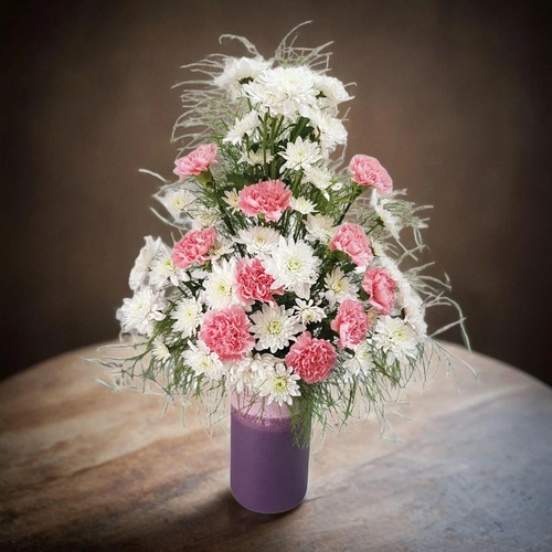 purple vase with white crase and pink carnation flowers 514 - This elegant purple vase, is beautifully adorned with a stunning arrangement of white crase and pink carnation flowers.  The vibrant colors of the blooms create a striking contrast against the rich hue of the vase, making it a perfect centerpiece for any setting. Ideal for enhancing the aesthetic of both modern and traditional decor, this floral display adds a touch of sophistication and charm to your home or office. dimensions  65 cm tall and 40 cm wide