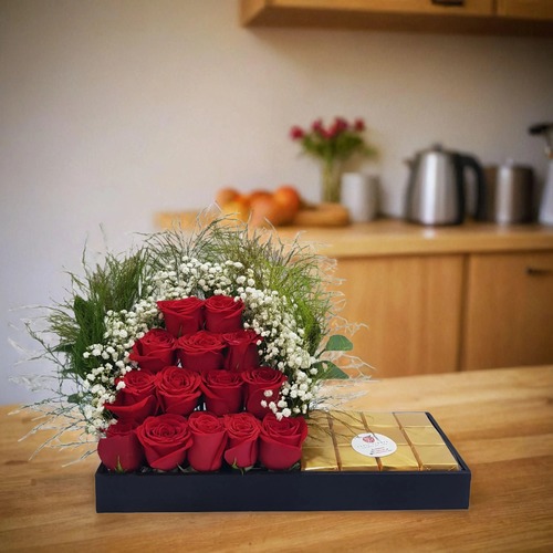 Roses With Gypsophilia And Chocolates In A Tray 1716 - the tray includes 14 roses,gypsophilia,and green trifan   The Arrangement Contains 12 wafer chocolates in a tray   height 25 cm width 50 cm