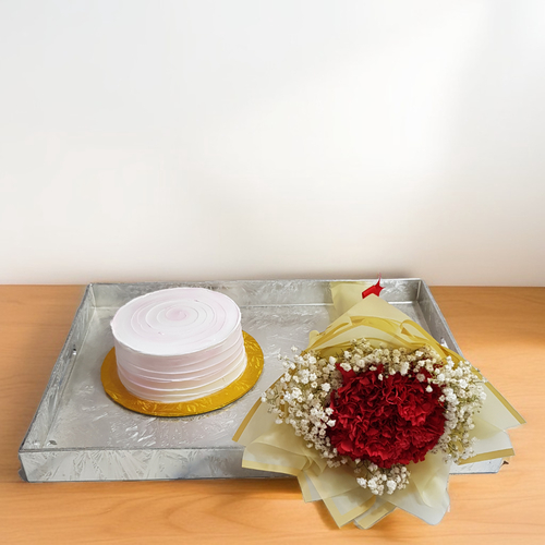 Cake with a bouquet ofCarnation and Gypsophilia in Silver acrylic Tray 1925 - A stunning cake with a bouquet of vibrant carnations and delicate gypsophilia, elegantly presented on a silver acrylic tray.   the cake diameter is 6 inch. from the inside Vanilla and chocolate. good for 2 to 4 person 
 height 20 width 48