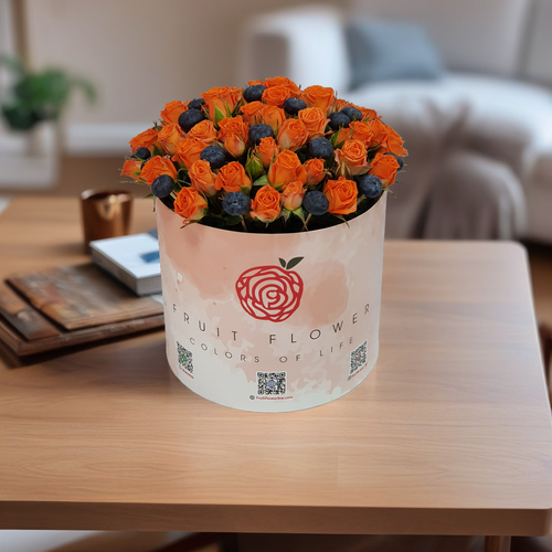 Orange baby Rose with Blueberries in Round Box 1515 - This elegant round box features beautiful baby orange roses, perfectly complemented by a touch of blueberry. Measuring 25 cm in height and 20 cm in width, it adds a charming touch to any occasion. This floral arrangement is ideal for gifts or home decor, bringing warmth and joy to any space.