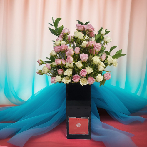 Baby Rose with Green Rescus in Acrylic Vase 535 - A charming arrangement of Baby Rose, accented with fresh green ruscus, beautifully displayed in a sleek acrylic vase. A delicate and modern touch for any space. Standing at an impressive height of 60 cm and a width of 35 cm,