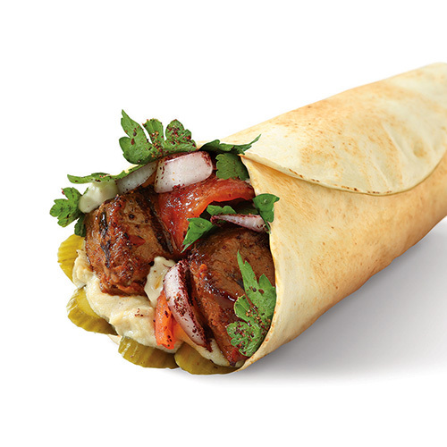 Classic Beef Sandwich - Grilled beef, hummus, grilled tomato and onion, biwaz & pickles in Lebanese bread.